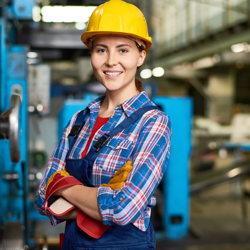 happy-young-woman-working-at-factory-DWN33CH.jpg